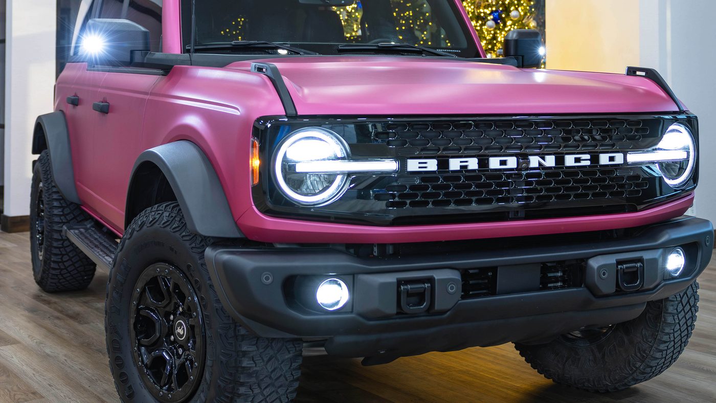 Ford Bronco in matte pink with auxiliary lighting and off-road wheels by Apex Custom Innovations