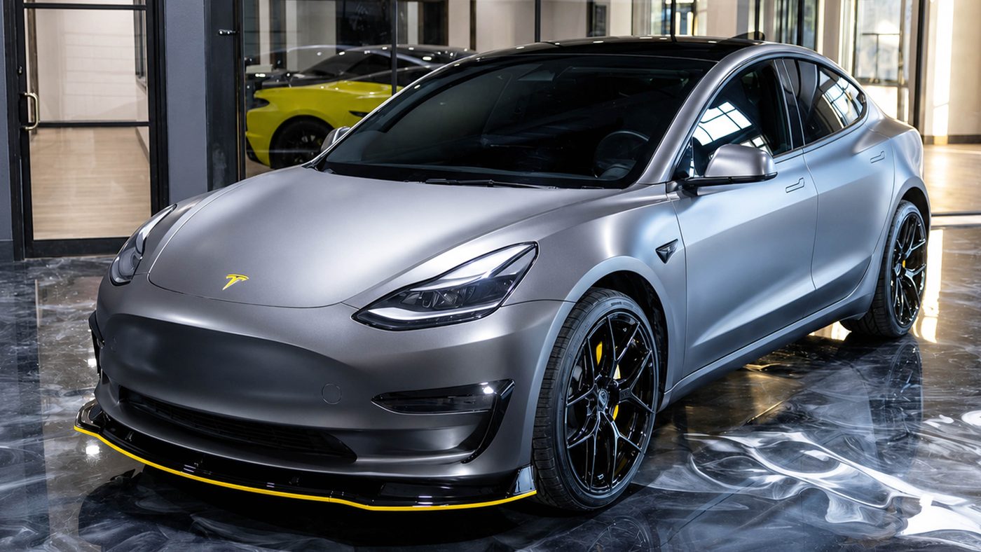 Tesla Model 3 in satin grey with tinted windows in the Apex Custom Innovations showroom