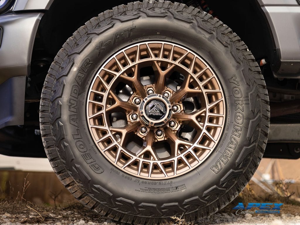 Fuel Off-Road bronze wheel and Yokohama Geolandar X-AT tire on a lifted 2025 Ford F-350 by Apex Custom Innovations