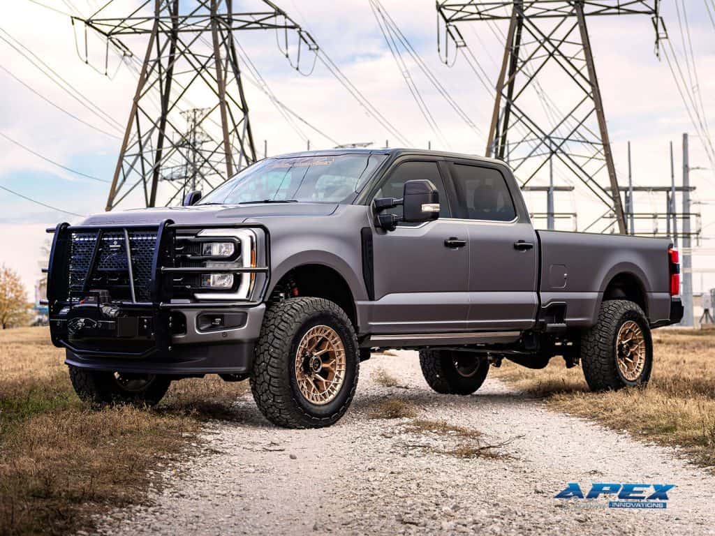 Side profile of a lifted 2025 Ford F-350 with ReadyLIFT suspension, Fuel Off-Road wheels, Yokohama all-terrain tires and Ranch Hand front bumper by Apex Custom Innovations