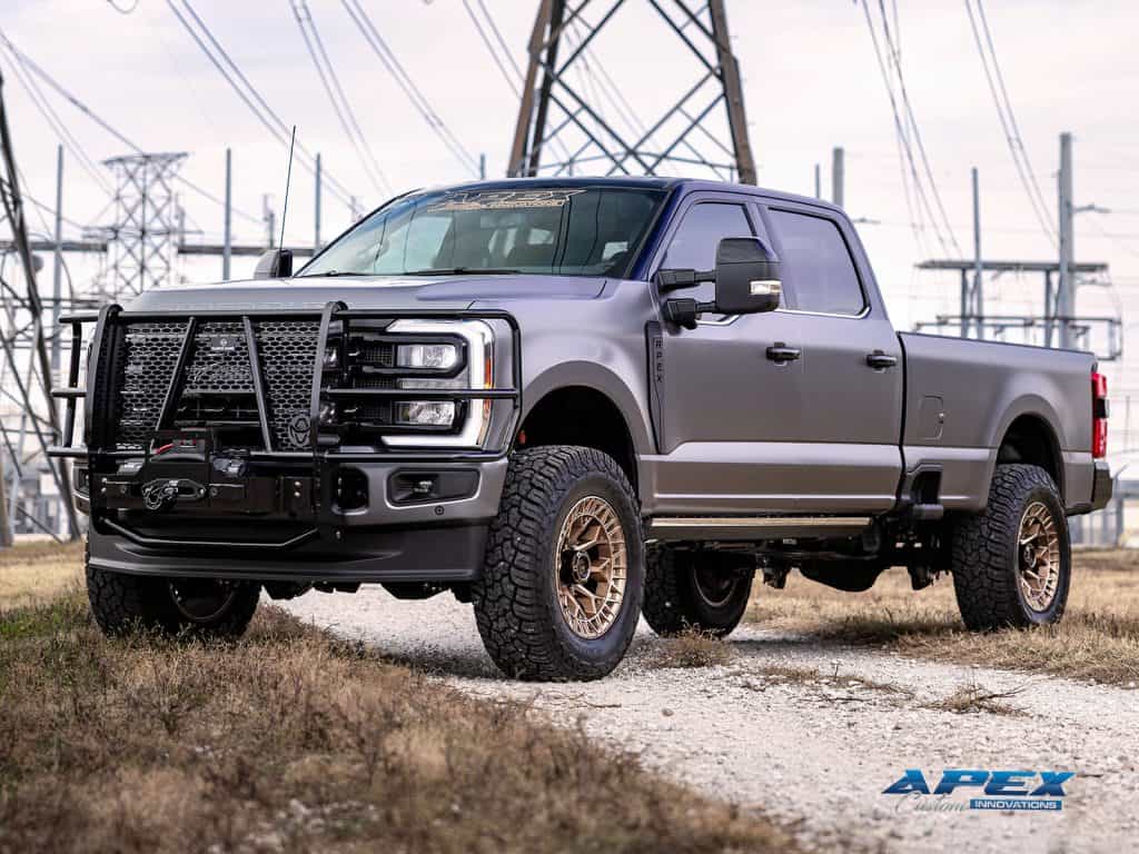 Front 3/4 view of a 2025 Ford F-350 with ReadyLIFT suspension, Fuel Off-Road wheels, Yokohama tires, Ranch Hand brush guard and XPEL Tarmac PPF by Apex Custom Innovations