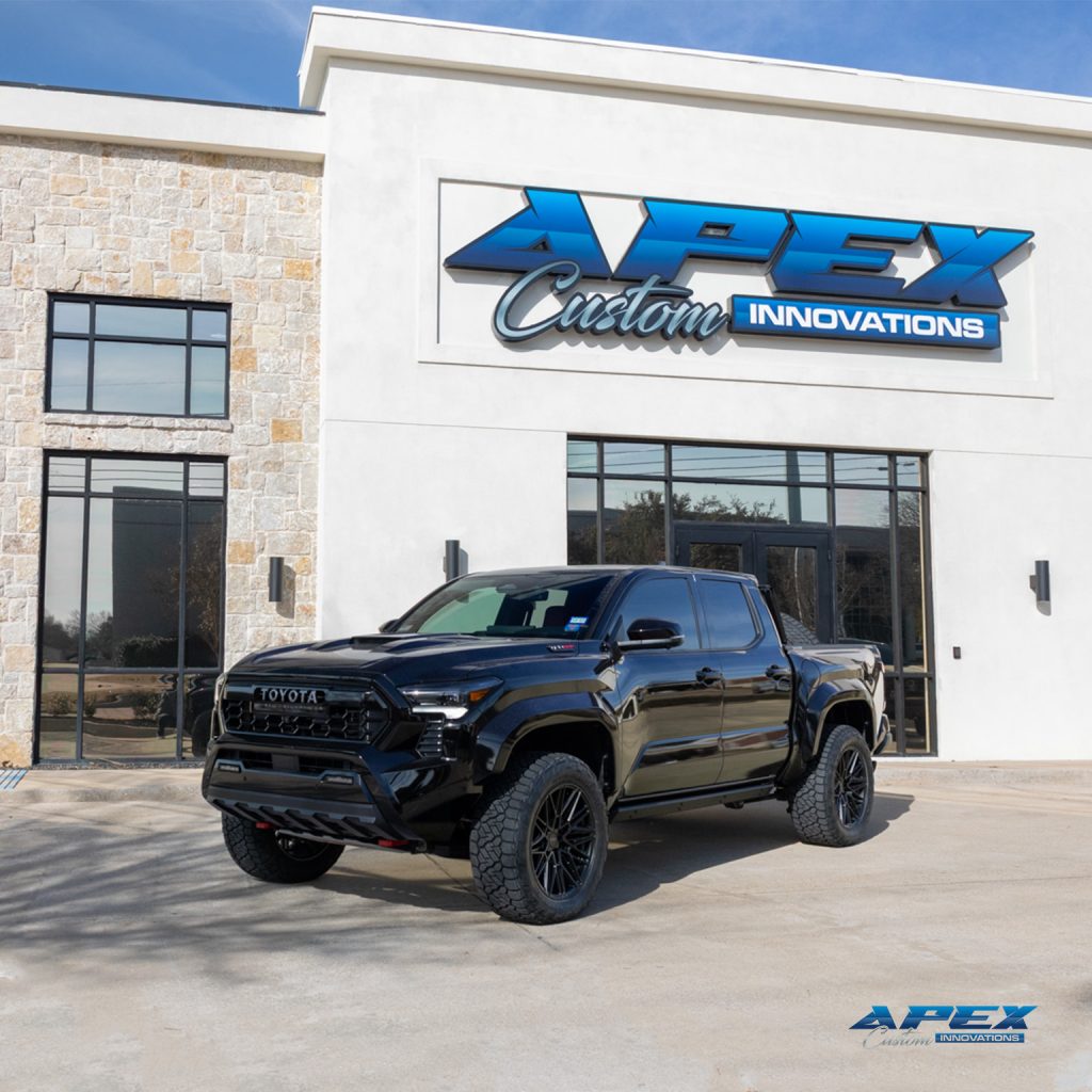 Front angle of a 2025 Toyota Tacoma TRD Pro with Vossen HF7 20-inch wheels and Nitto Recon Grappler tires built by Apex Custom Innovations in Dallas Texas
