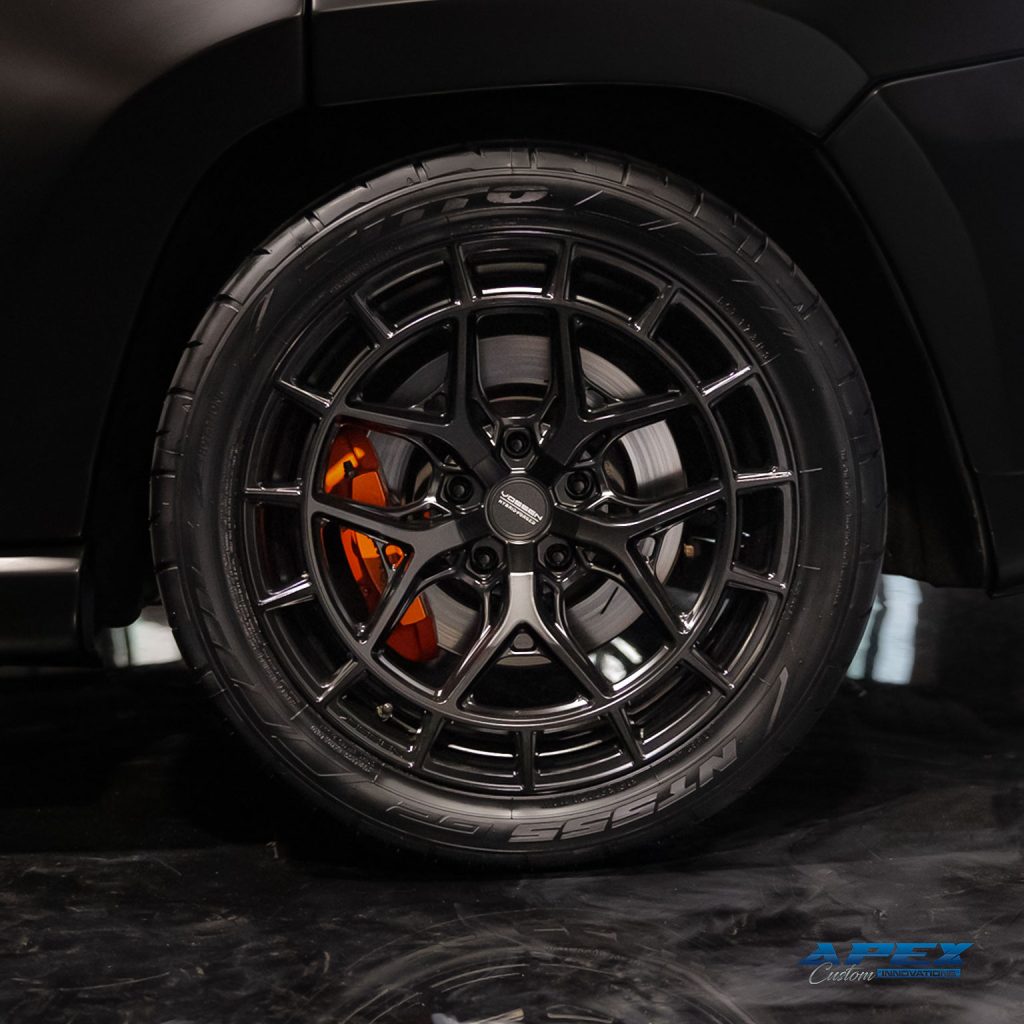 Close-up of Vossen HFX1 wheel and Nitto NT555 tire on a Jeep Grand Cherokee Trackhawk widebody built by Apex Custom Innovations in Dallas Texas