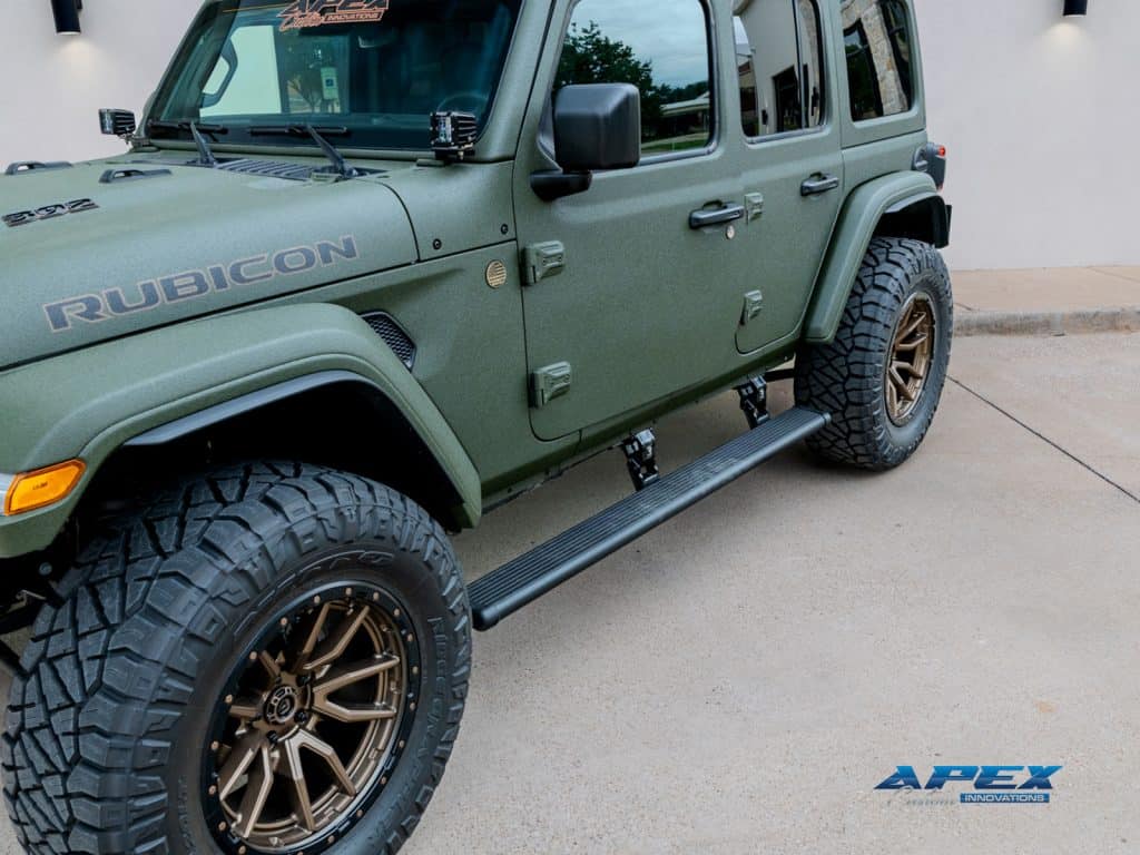 AMP Research power running boards on 2025 Jeep Wrangler Rubicon 392 with Sarge Green Apex Armor and bronze Fuel Rebel wheels